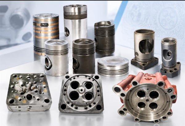 Full power assembly showing cylinder head, piston, connecting rod, and cylinder liner on industrial background